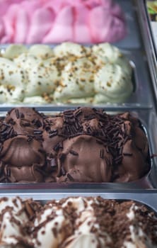 Display counter with assorted ice cream flavours. Selective focus