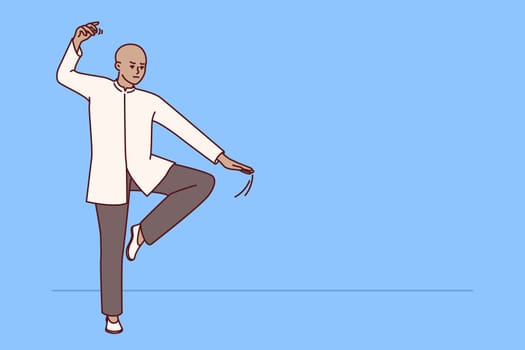 Chinese man practicing qi qong taijiquan does breathing exercises during martial arts training. Specialist in traditional chinese martial gymnastics demonstrates smooth movements for warm-up