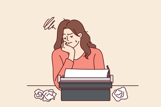 Woman with typewriter feels sad about lack of inspiration and professional burnout in career as writer. Girl writer uses vintage equipment and gets upset after making mistake in text