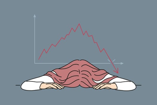 Bankrupt businesswoman put head on table near chart demonstrating crisis fall of stock market. Bankrupt woman investor upset by bad news about stock price decline or fed rate cut for lending