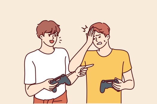 Men play video game and hold joysticks for computer or console during home esports tournament. Young guy gets upset after losing to friend in video game of virtual football or racing simulator