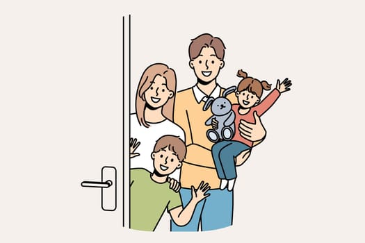 Family with children stands near door, inviting guests to banquet and waving hands in greeting. Young family with kids looks at screen in friendly way, posing on threshold of new apartment.