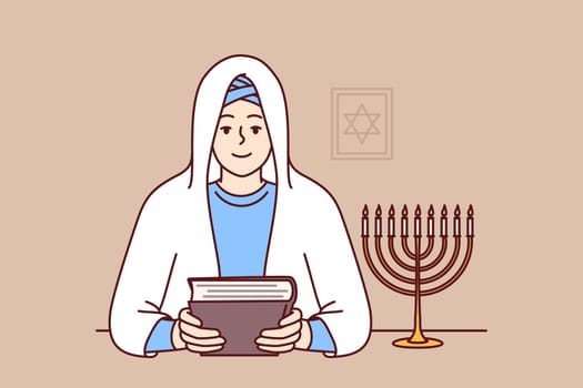 Jewish woman rabbi holds torah in hands and sits near image of star of david, dressed in religious clothes and white veil. Smiling girl learning jewish religion and prayers to worship god