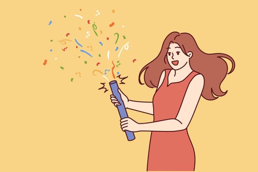 Woman launches confetti during birthday or university graduation party. Girl in beautiful evening dress holds firecracker with confetti, wanting to cheer friends gathered at festive disco