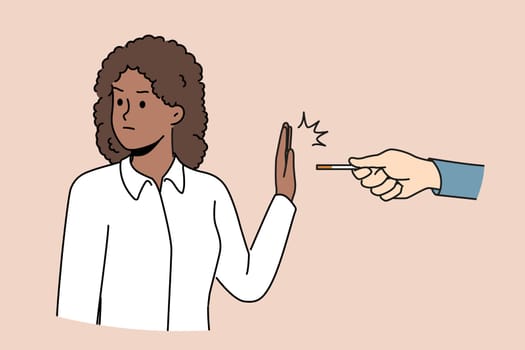 African American woman refusing to smoke making prohibition gesture near hand with cigarette made of tobacco and nicotine. Ethnic girl wants to quit smoke and fight addictive bad habits