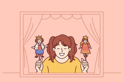 Girl performs in puppet theater showing scene with prince and princess for concept of children creativity. Little schoolgirl smiles after participating in theater production for classmates