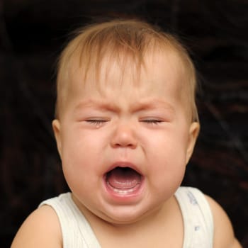 Portrait of nine month baby crying very emotionally