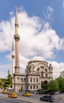 Istanbul, Turkey - May 7, 2023: View from Meclis-i Mebusan Street overlooking Baroque style Dolmabahce Mosque, suited at the waterside of Kabatas, in Beyoglu district