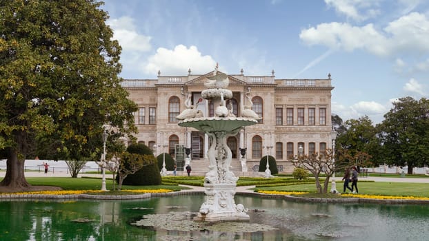 Istanbul, Turkey - May 10, 2023: Dolmabahce Palace, or Dolmabahce Sarayi, located in Besiktas district on the European coast of the Bosporus, with water fountain in front of the palace