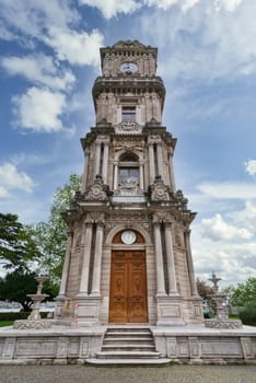 Day shot of Dolmabahce Clock Tower, Turkish: Dolmabahce Saat Kulesi, situated outside Dolmabahce Palace, Istanbul, Turkey, in a spring day