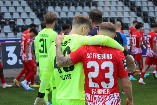 Team spirit in action: Goalkeeper Sauter Niklas (SC Freiburg II U23) and Philip Fahrner (SC Freiburg II - U23) on their way to the team photo SC Freiburg II - U23 - Season 2023/24 -