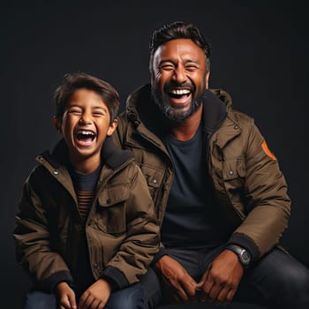 Father and son laughing at family pictures