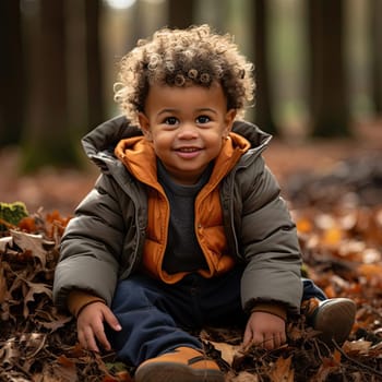 Stylish little boy among autumn leaves in the woods