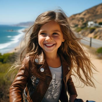 Young girl with long hair riding a bike by the beach
