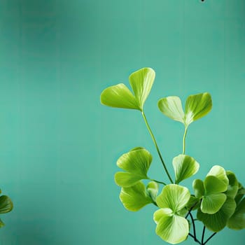 Green leaves hanging on a turquoise background with a serene feeling (tiled)