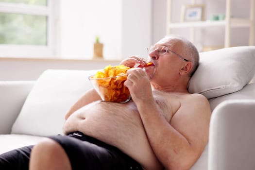 Sitting Overeating Food Lifestyle. Overweight People Watching Television