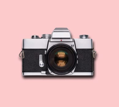 vintage old film camera on pink background with shadow