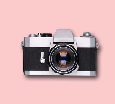 vintage old film camera on pink background with shadow