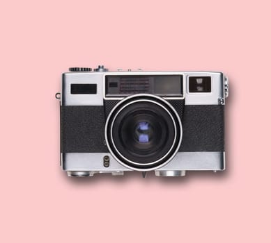 vintage old film camera on pink background with shadow