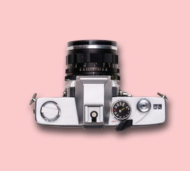 vintage old film camera on pink background with shadow
