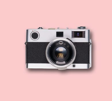 vintage old film camera on pink background with shadow