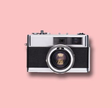 vintage old film camera on pink background with shadow