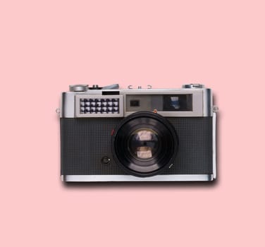 vintage old film camera on pink background with shadow