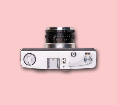 vintage old film camera on pink background with shadow