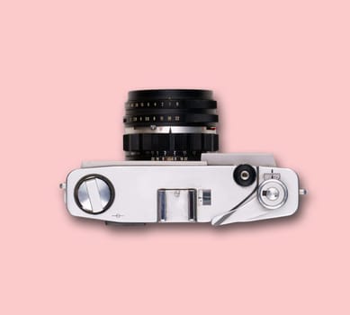 vintage old film camera on pink background with shadow