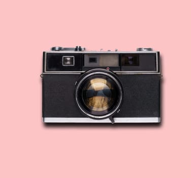 vintage old film camera on pink background with shadow