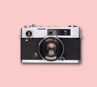 vintage old film camera on pink background with shadow