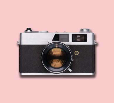vintage old film camera on pink background with shadow