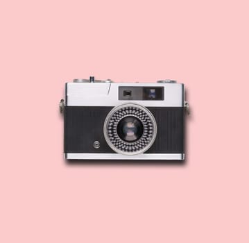 vintage old film camera on pink background with shadow