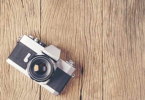 vintage old film camera on wood board with copy space