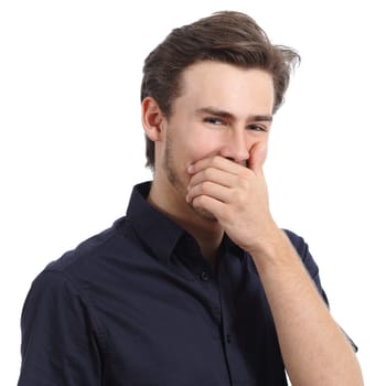 Handsome man laughing while covering his mouth with a hand isolated on a white background