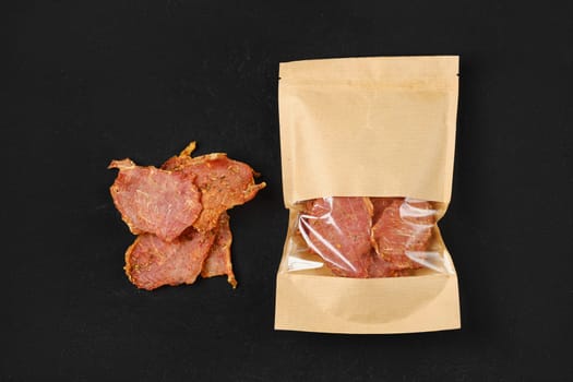 Top view of of spicy jerky pork meat in paper package