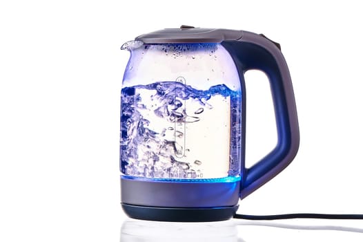 Glass electric kettle with boiling water on a white insulated background. High quality photo
