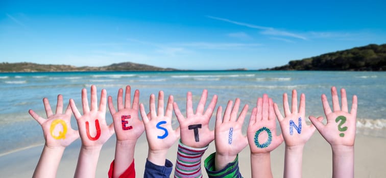 Children Hands Building Colorful English Word Question. Summer Sea, Ocean And Beach Background