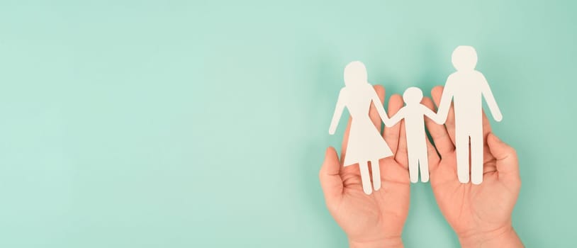 Parents with one child holding hands, relationship in family, care and security concept, charity and insurance, paper cut out