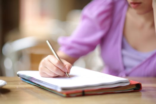 Close up portrait of a student writing notes in a bar terrace