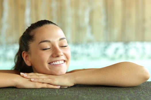 Happy woman smiling in spa pool