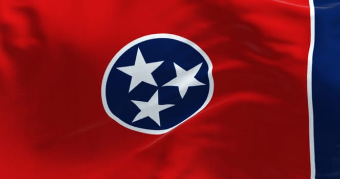 Close-up of the Tennessee state flag waving. Red field with a blue circle in the center containing three white stars. US state flag. 3d illustration render. Fluttering fabric