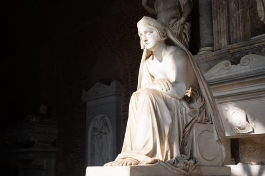 Pisa, Italy - June 2023: catholic cemetery, antique statue of sad woman, by Lorenzo Bartolini, 1841
