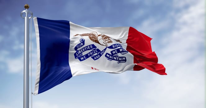 Iowa state flag waving in the wind on a clear day. Tricolor of blue, white, and red with an eagle holding a ribbon in the center. 3d illustration render. Fluttering fabric.