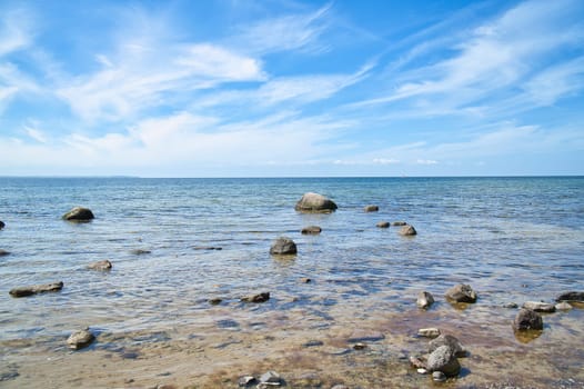 Stones and rocks on the Baltic coast in the sea. Landscape shot in sunshine. Nature from germany