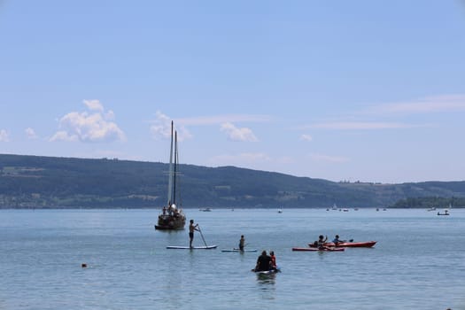 Theme picture Summer - Summer day at Lake Constance  Even at Lake Constance,as here near Allensbach,people were drawn to or to the water on this hot weekend. Young and old sought to cool off on a boat trip,an excursion with the Stand Up Paddle (SUP) or while swimming. The next few days are expected to remain hot in summer if thunderstorms are likely to occur