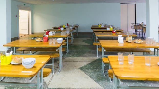 Cafeteria, dining room in a university, cafe with tables and chairs, counter bar hotel.