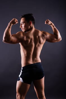 Muscular and torso of a young man having abs, bicep and chest. Male hunk with athletic body.