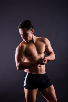 Muscular and torso of a young man having abs, bicep and chest. Male hunk with athletic body.