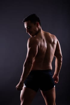 Muscular and torso of a young man having abs, bicep and chest. Male hunk with athletic body.